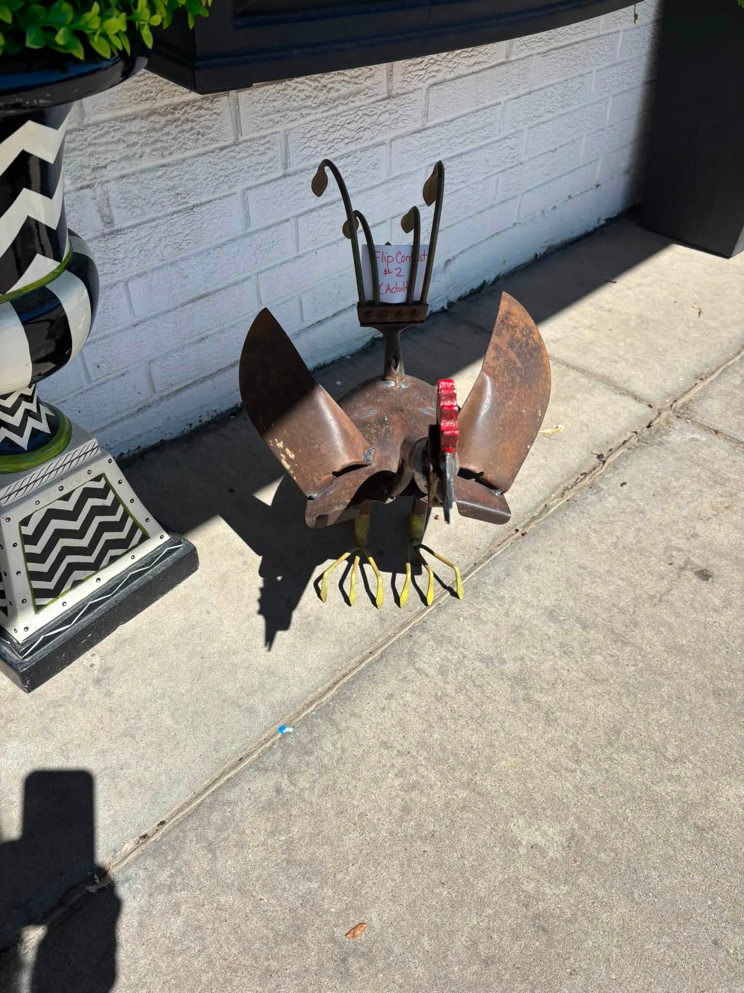 Flip Contest entry — rustic metal welded creature sculpture with yellow claws