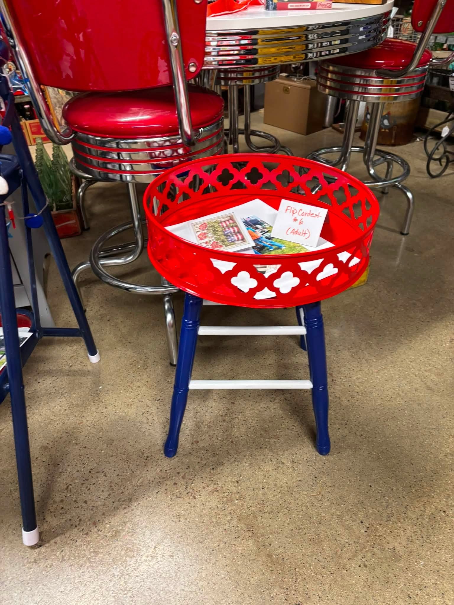 Flip Contest entry — red lattice basket tray on blue-legged stool