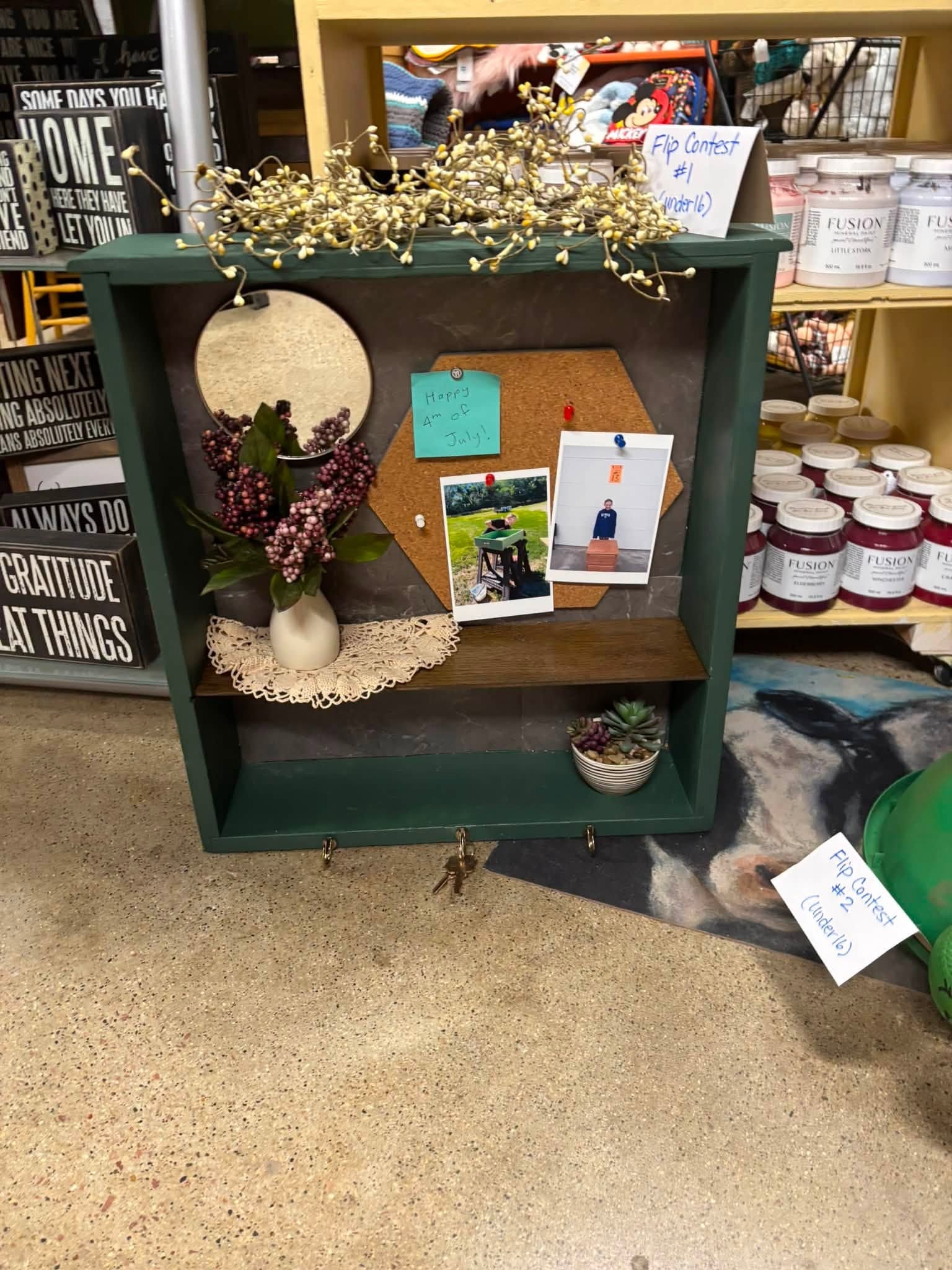 Flip Contest entry — green painted shelf with cork board, mirror, and decorative styling