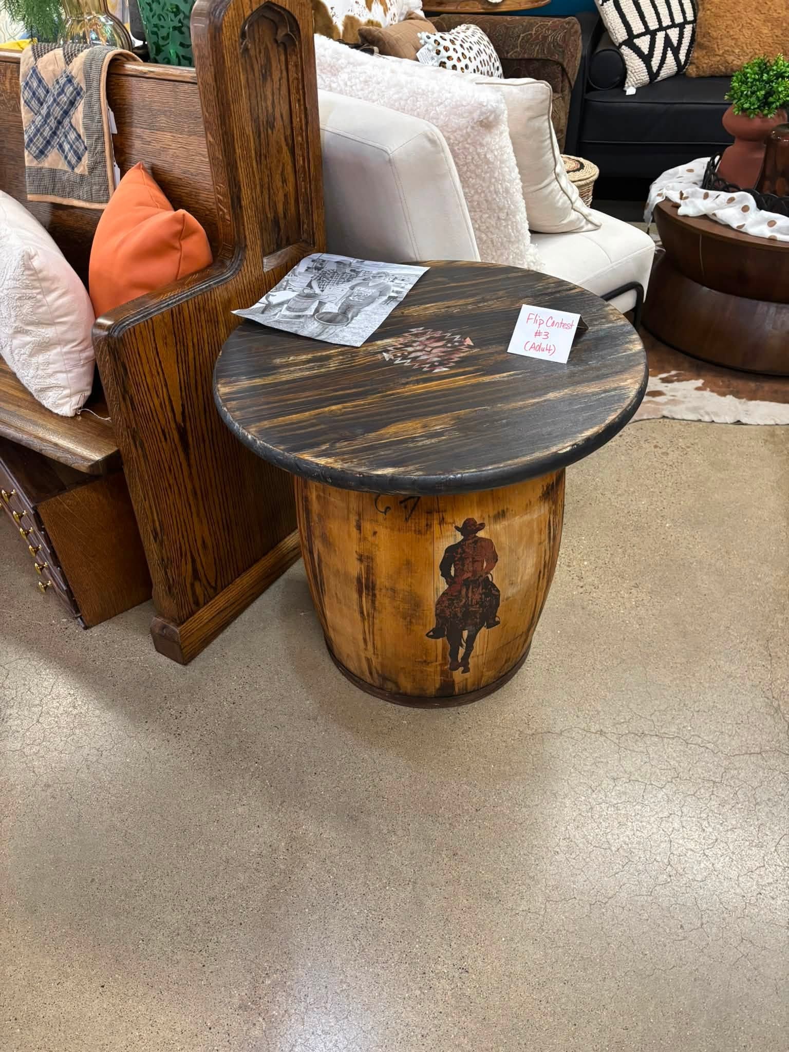 Donna Knippling's winning flip — a rustic barrel table with a cowboy stencil and dark-painted top