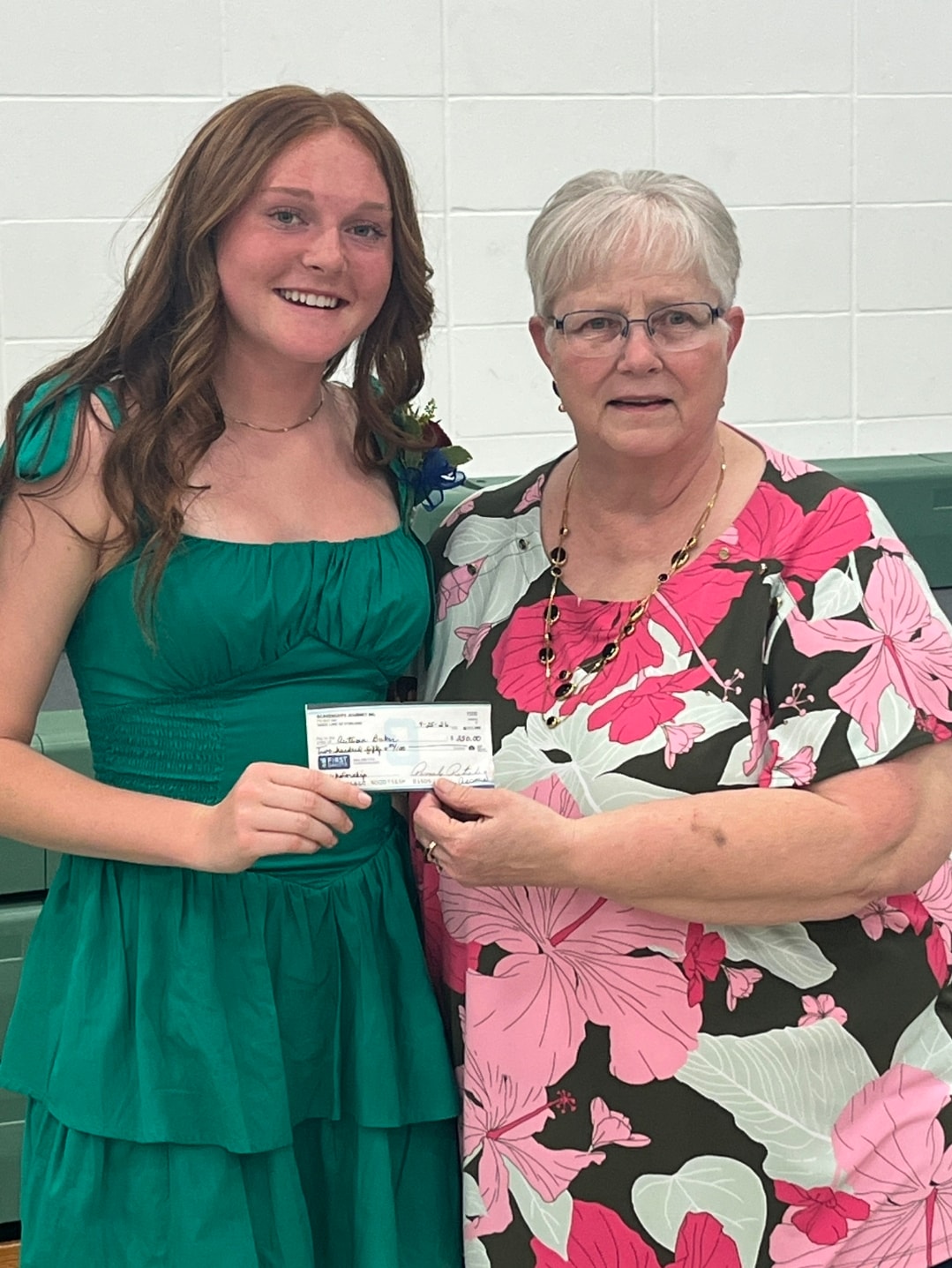 Connie Assmus presenting the $250 scholarship check to 2026 winner Autumn Rose Baker of Kimball, SD